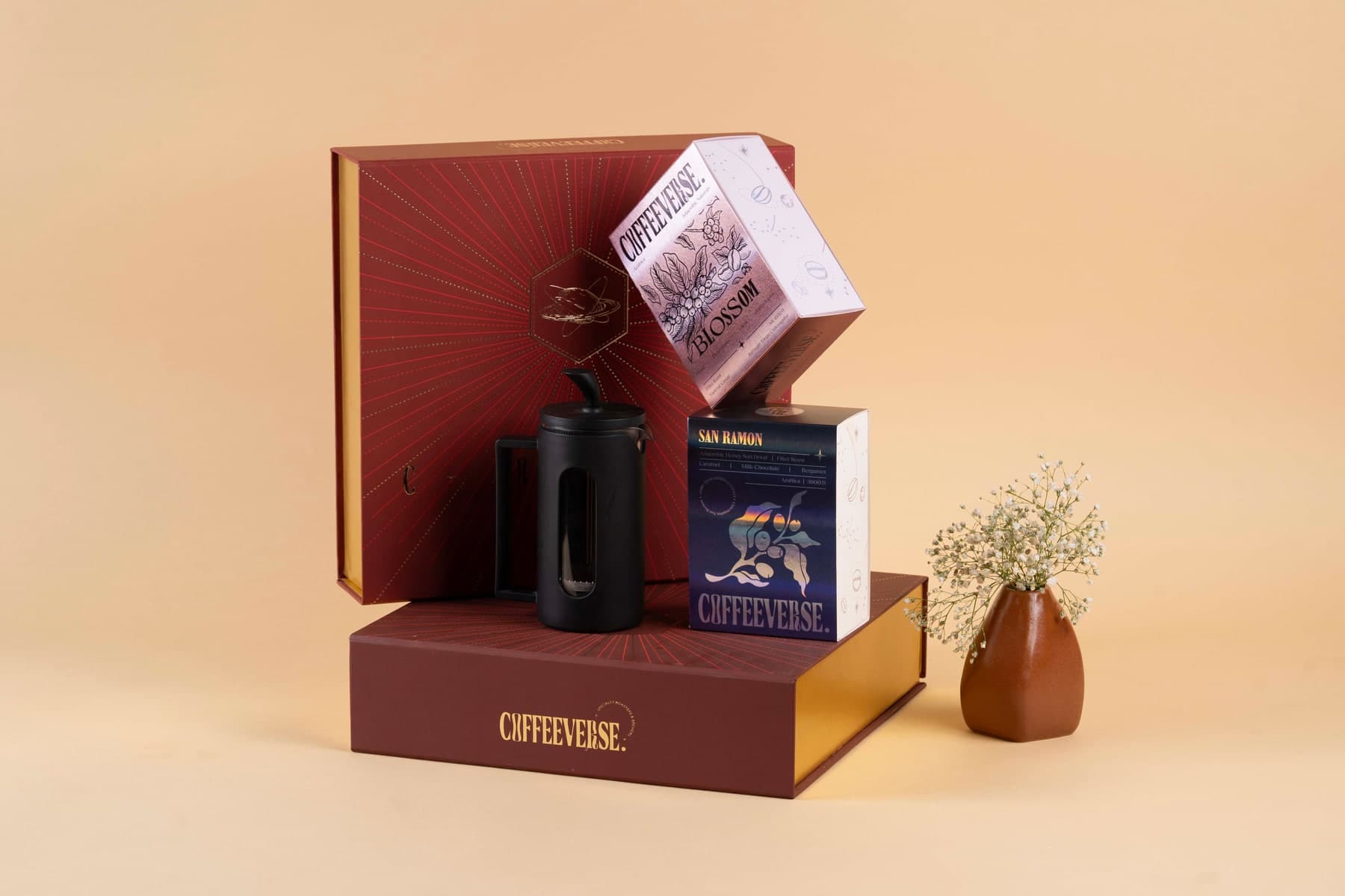 Coffeeverse gift box with coffee packaging and a black travel mug