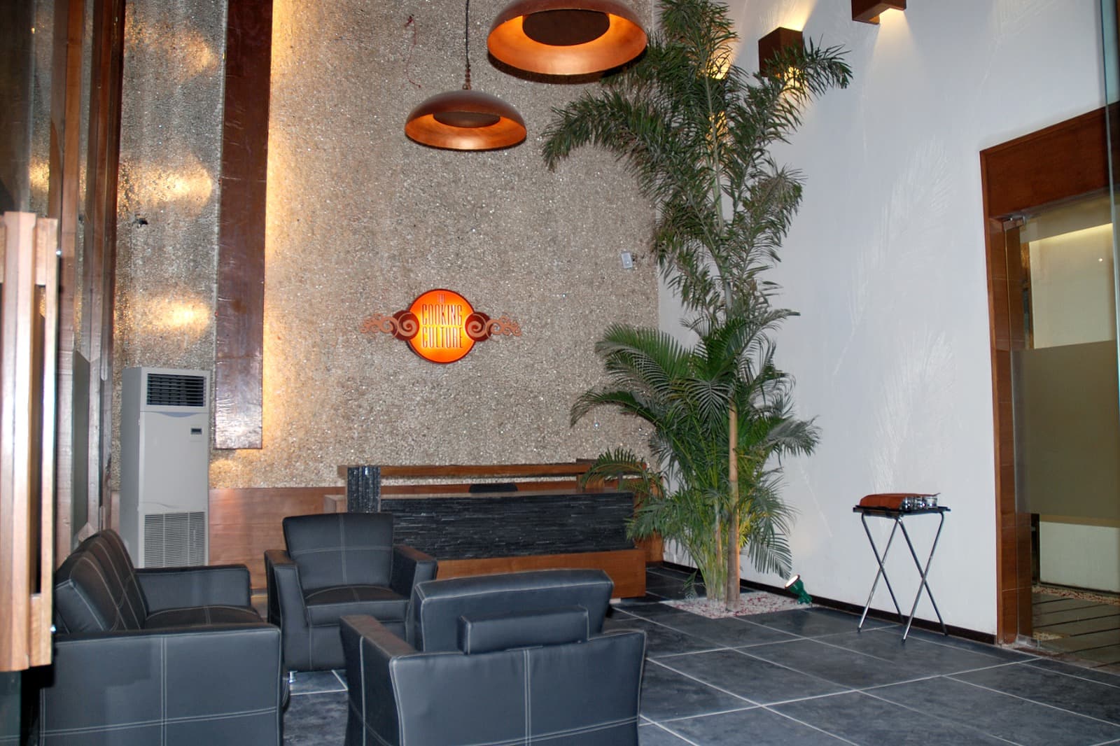 The Cooking Culture lounge with copper pendant lights and a feature wall