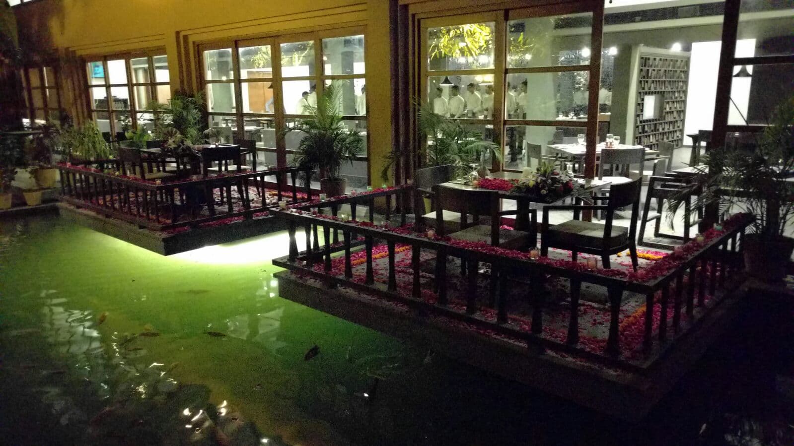 @Mango timber deck over the pond, lit at night