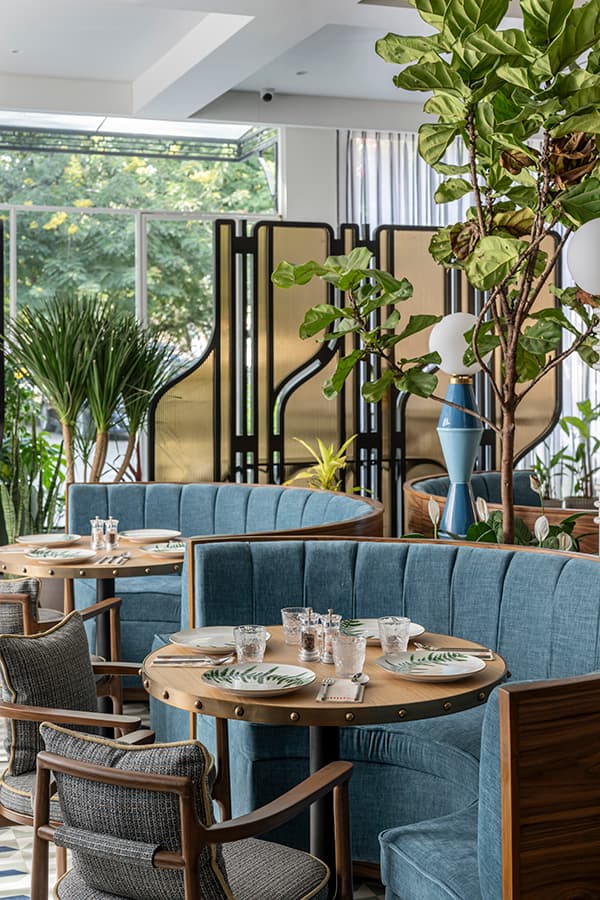 Booth seating beside the brass and timber screen