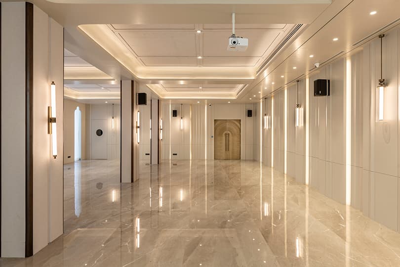 Banquet hall with recessed ceiling lighting and a marble floor