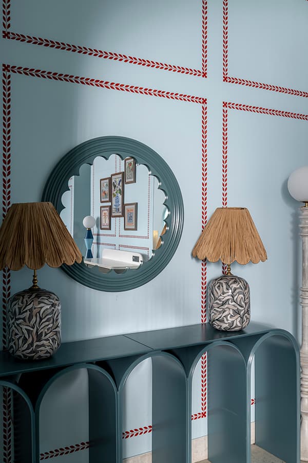 Scalloped mirror and lamp on an arched console