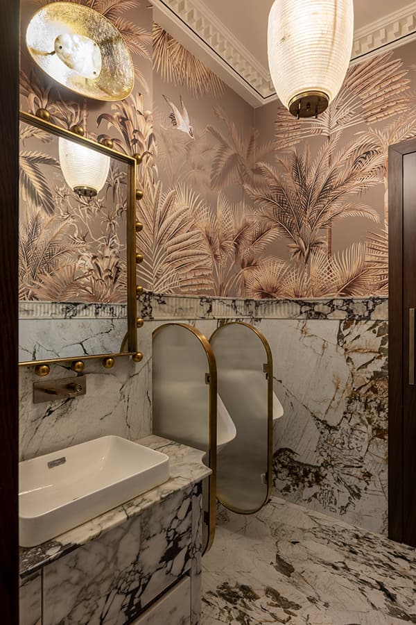 Powder room with botanical wallpaper and marble