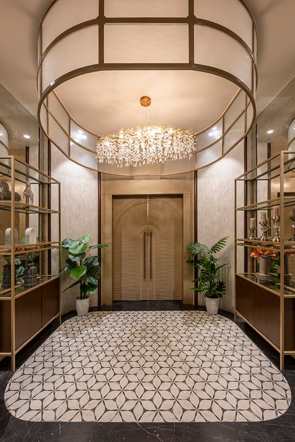 Entrance foyer with a chandelier and patterned floor