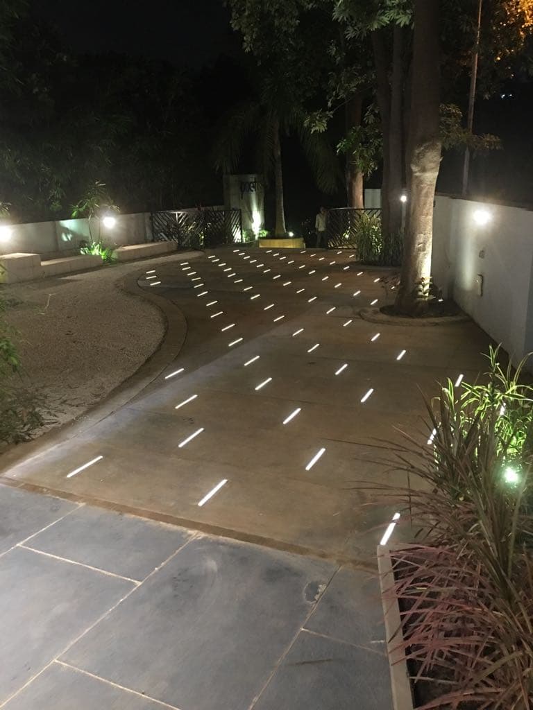 Lit garden path leading to the entrance at night