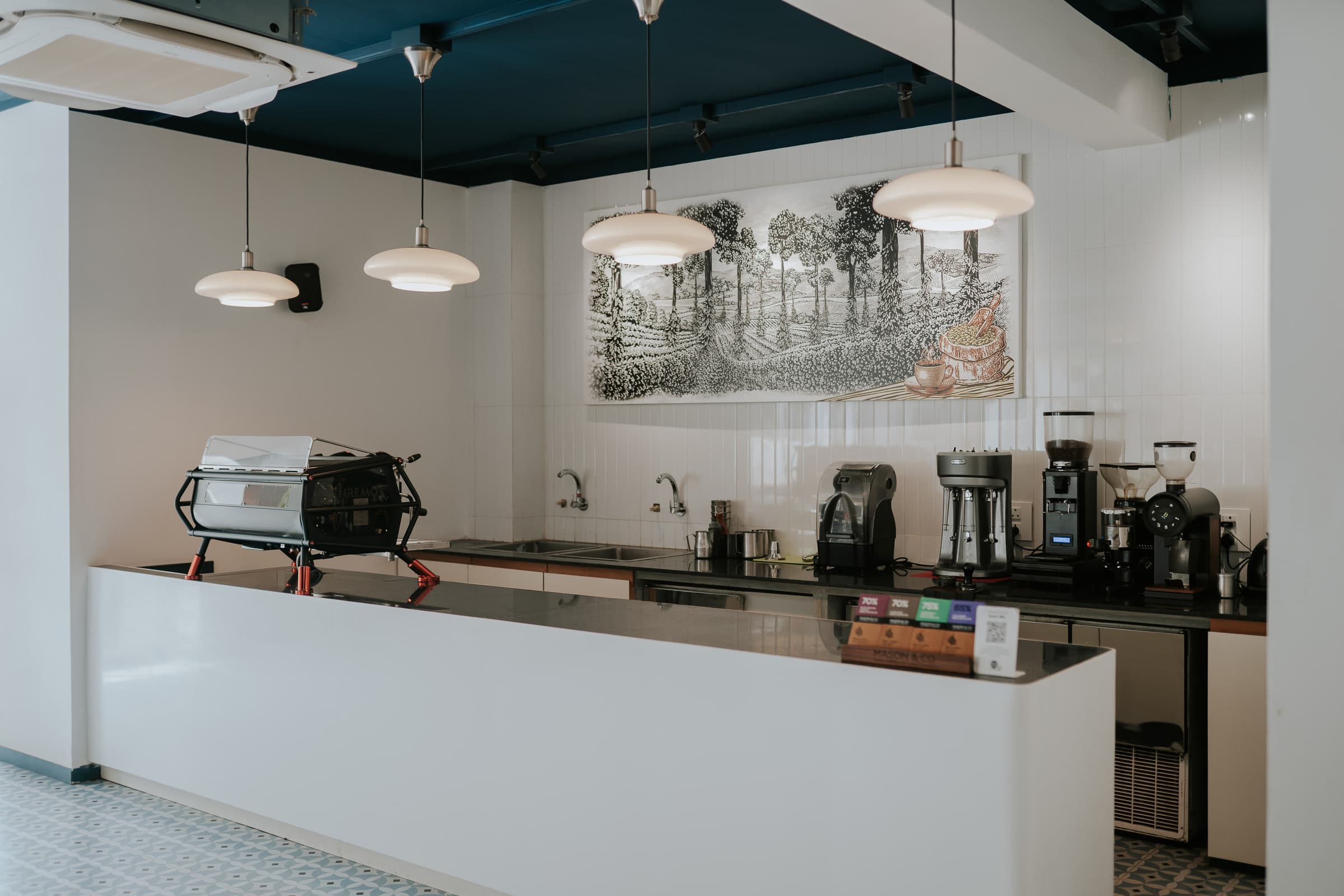 The espresso bar beneath an etched-glass panel