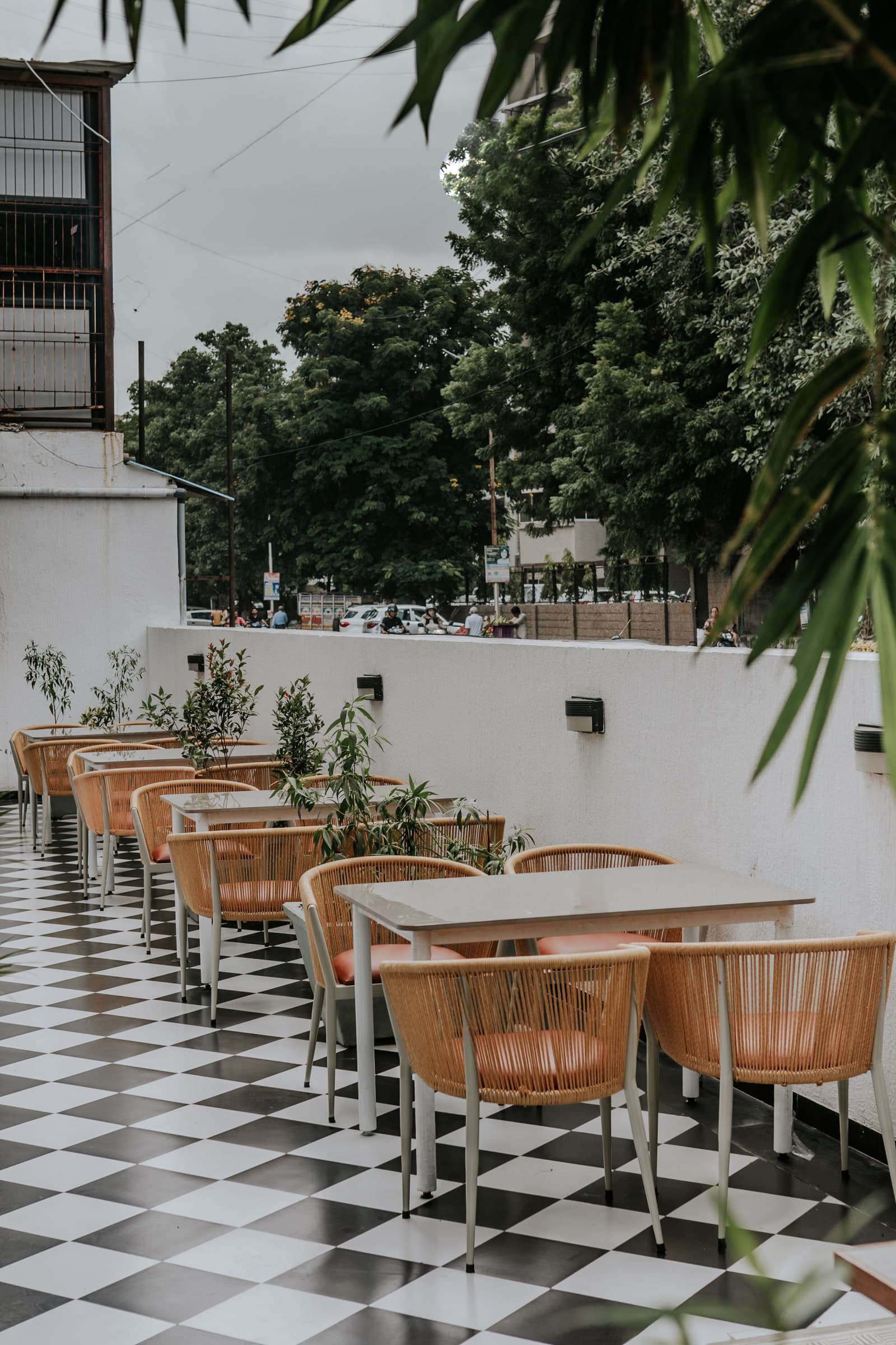 Terrace seating beside the planting, on chequered tiles