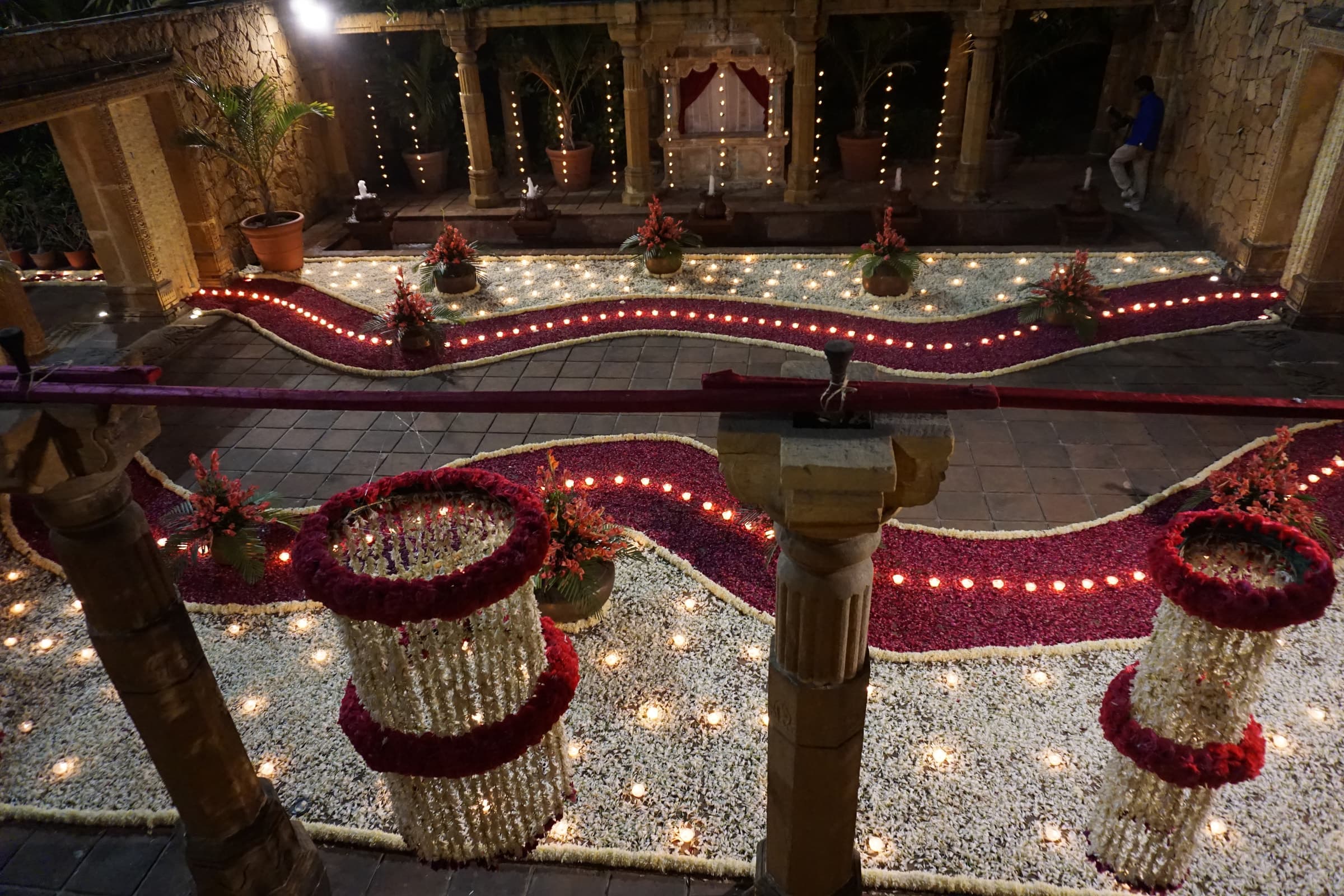 Circular floral installations and lamps on the courtyard floor