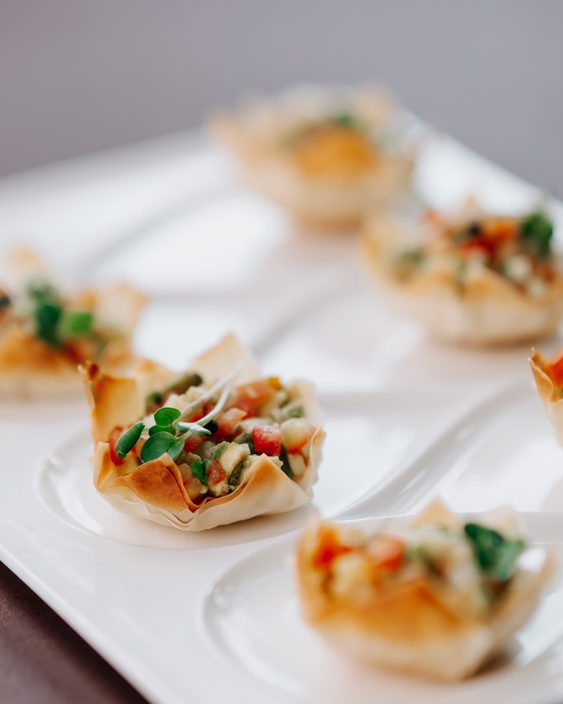 Canapés on a white plate in soft light