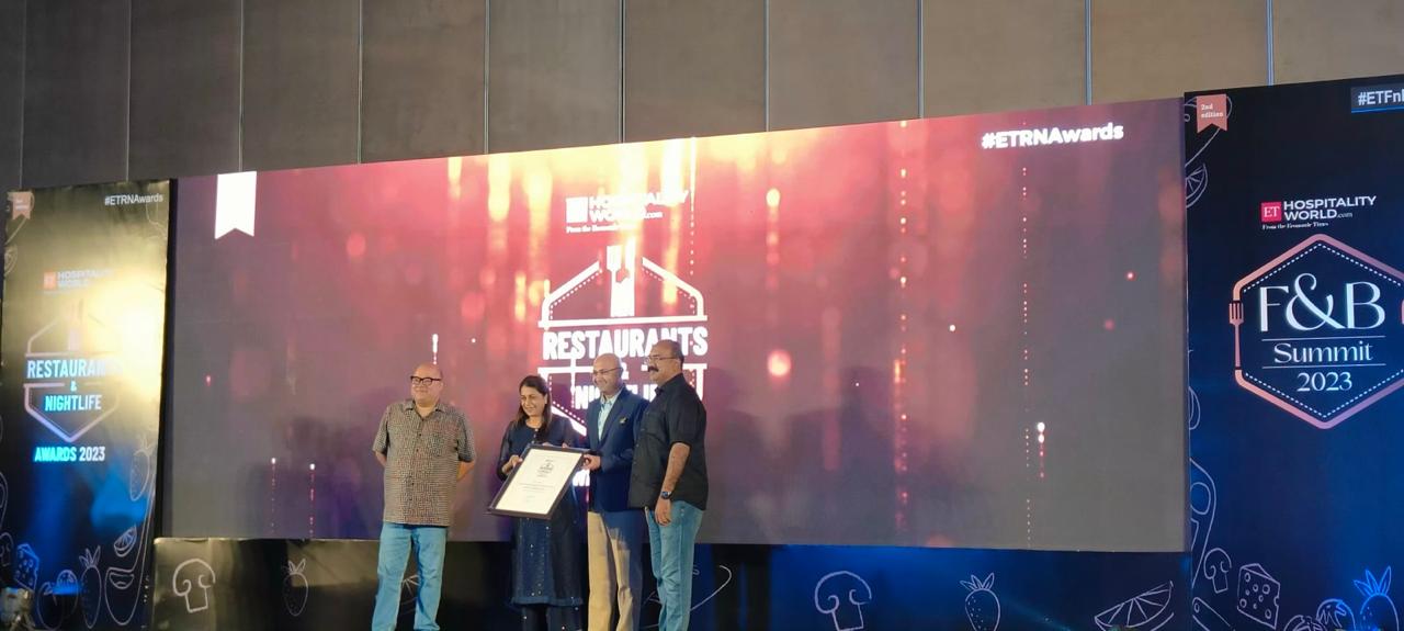 Receiving the Restaurant Consultant of the Year award on stage
