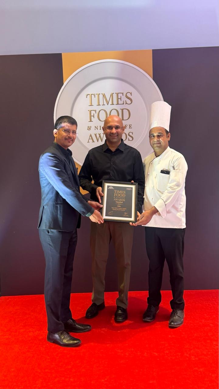 The team and a chef holding their Times Food Award