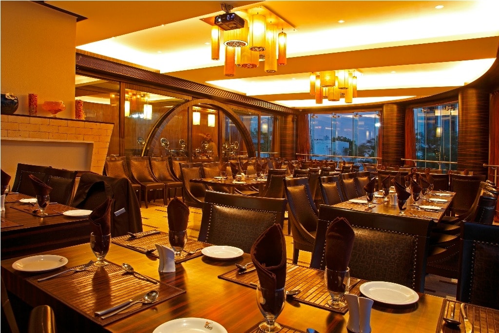 7 Chefs dining room set for service under amber pendant lights