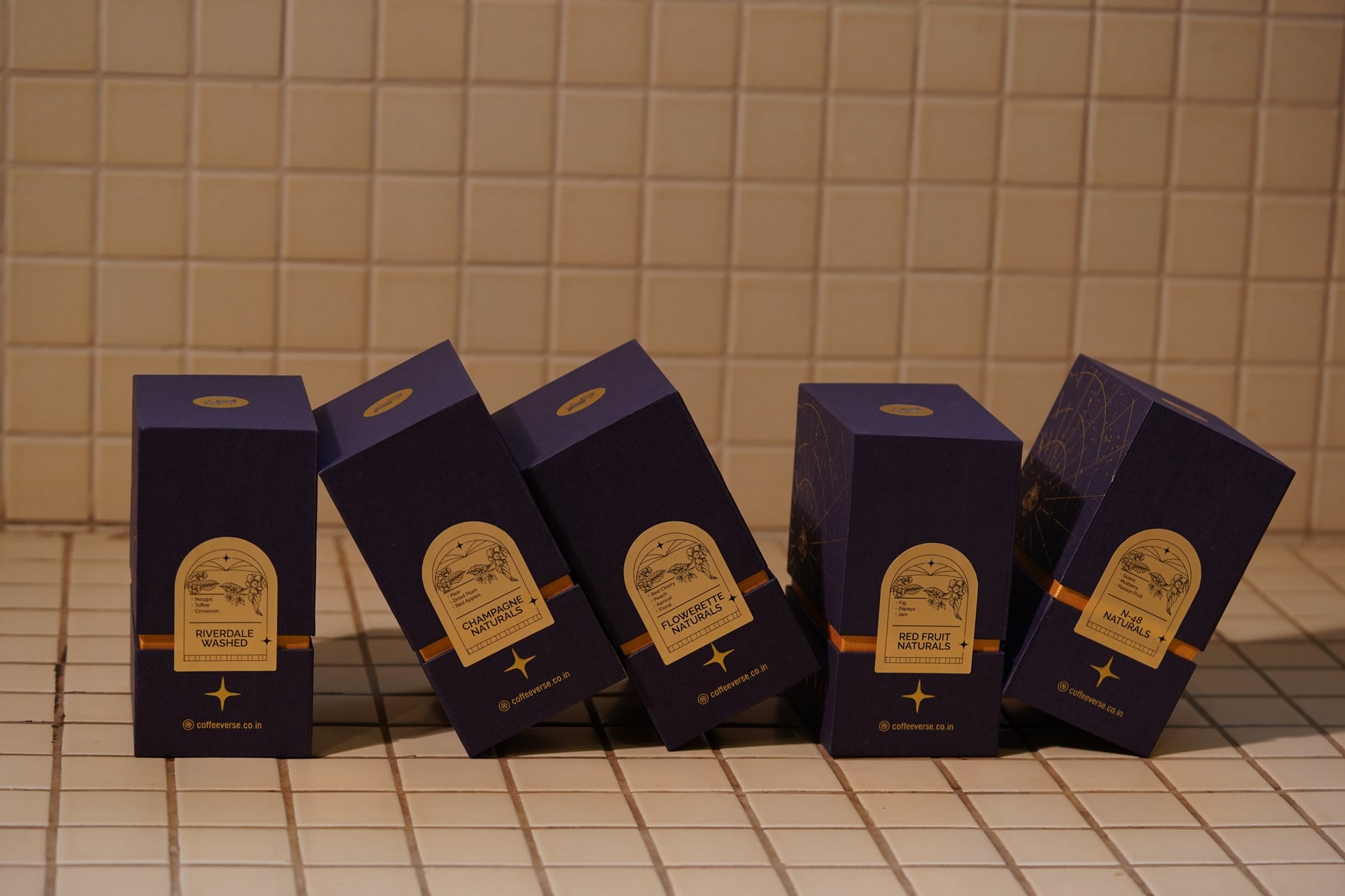 Coffeeverse purple coffee boxes on a tiled counter