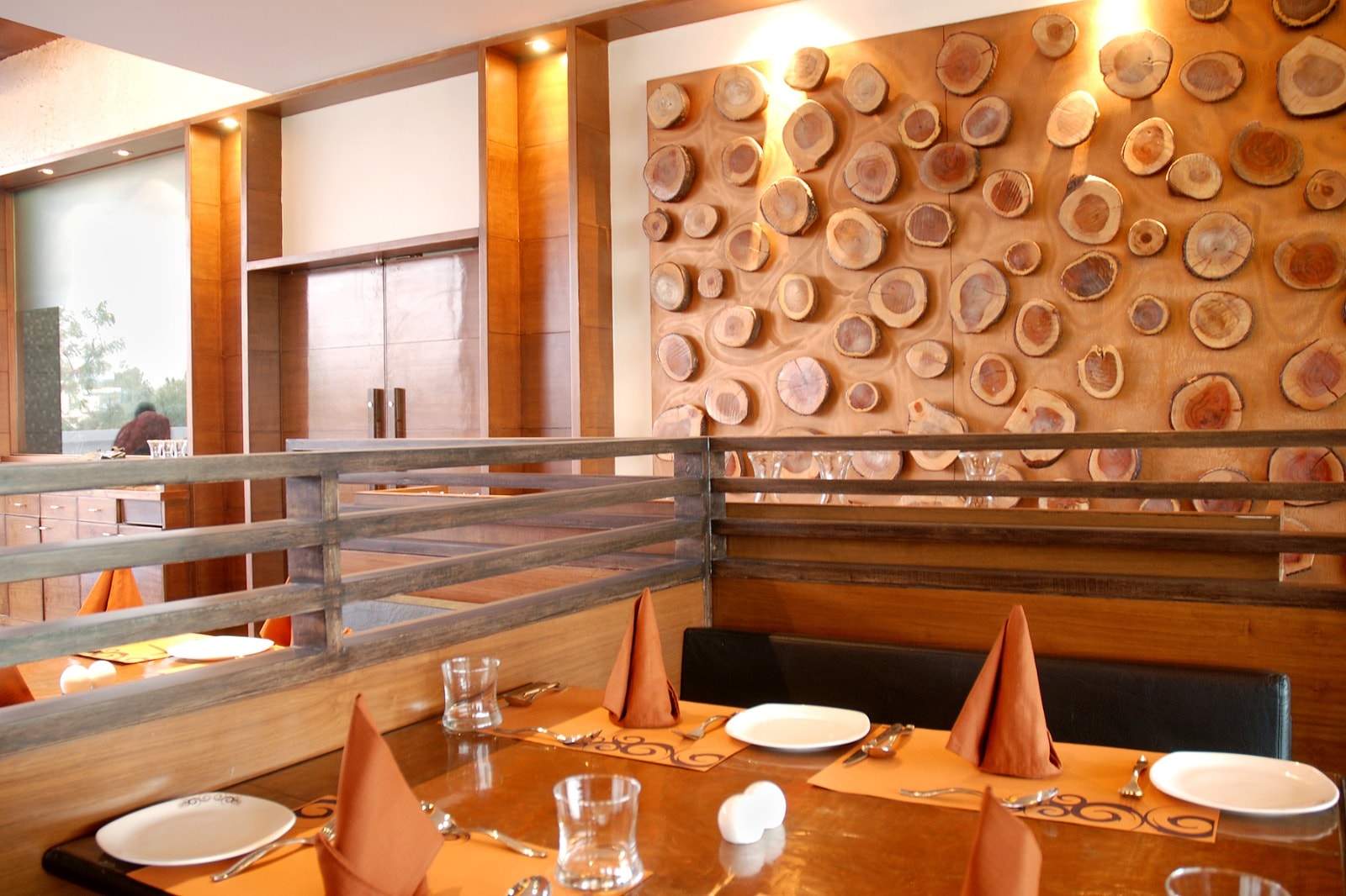 The Cooking Culture table setting against a wall of wood-slice art