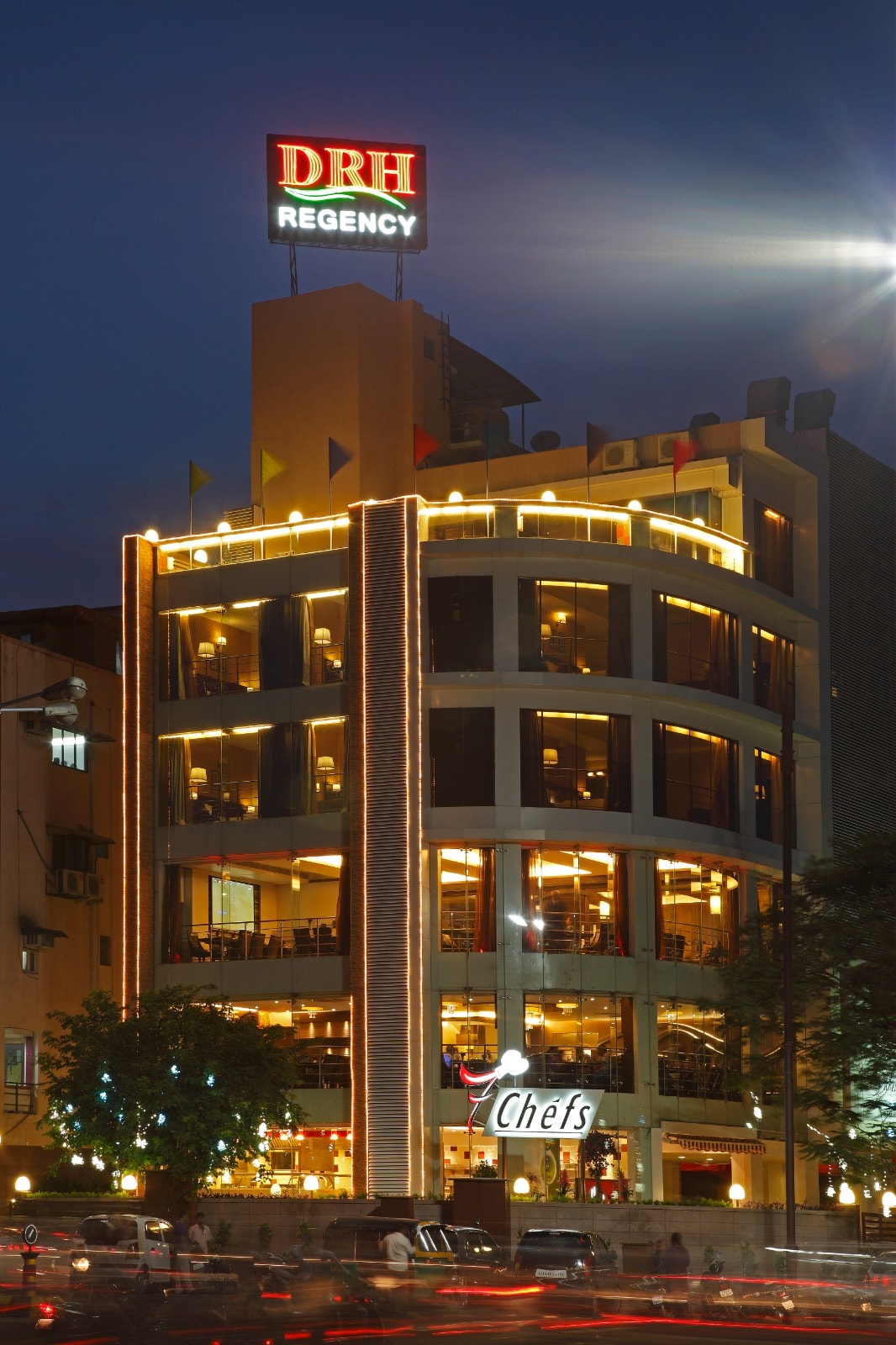 DRH Regency lit up at night, with the Chefs restaurant at street level