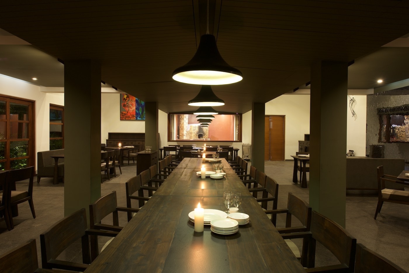 @Mango dining hall with a long communal table under pendant lights