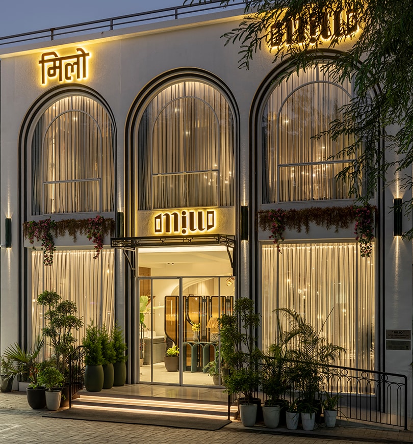 Millo Nagpur entrance at dusk, arched windows glowing with warm light
