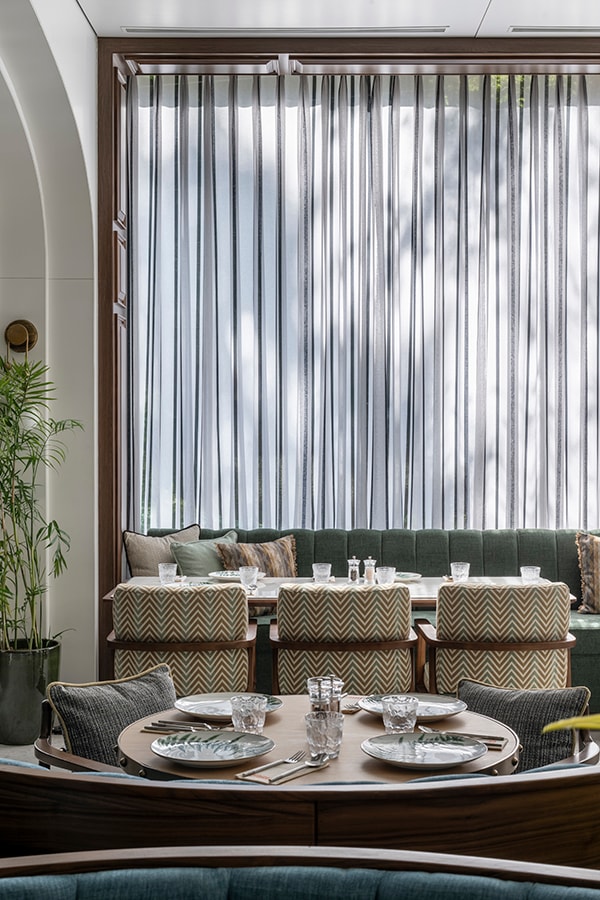 Window seating with sheer curtains in the dining hall