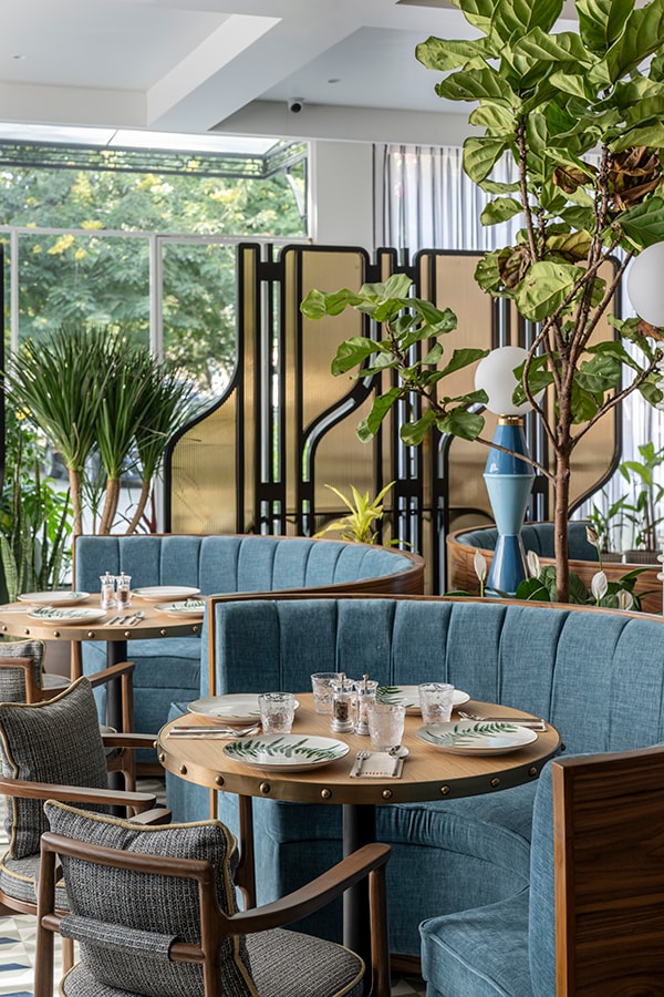 Booth seating beside the brass and timber screen