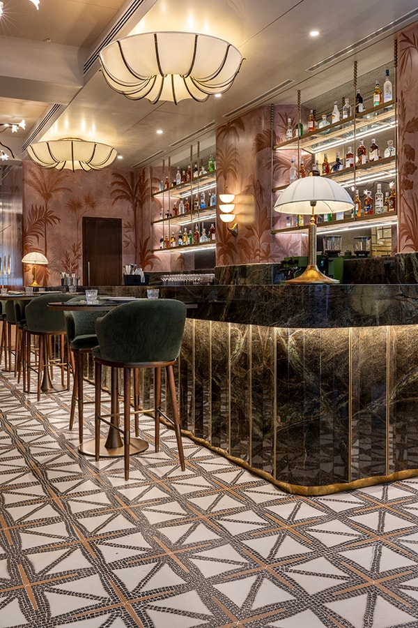 Bar counter with brass trim and geometric tile flooring