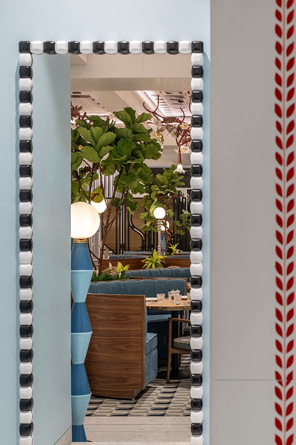 Mirror with a monochrome border and red woven trim