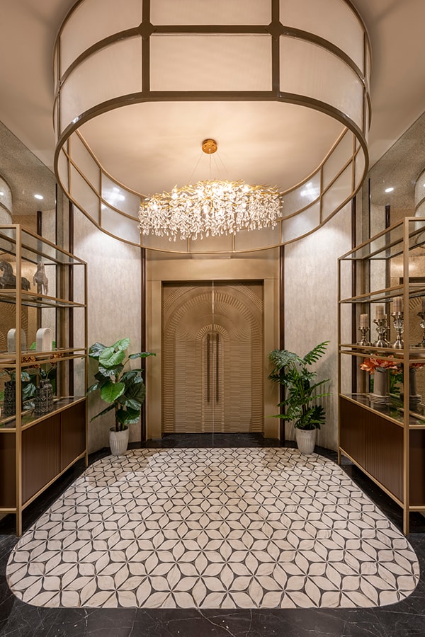 Entrance foyer with a chandelier and patterned floor