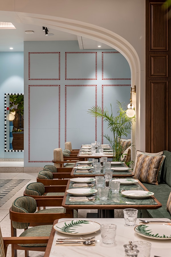Long communal table beneath an arched opening in the dining hall