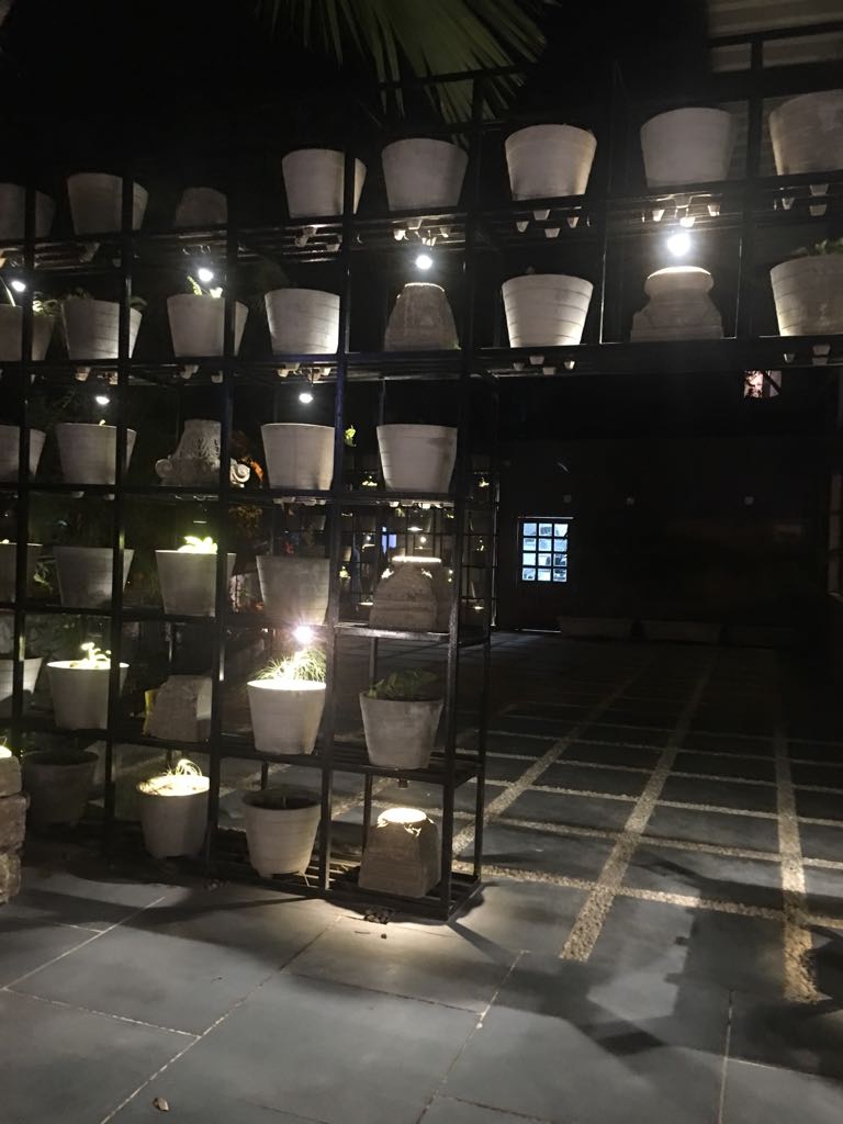 Illuminated planter wall lit with candles