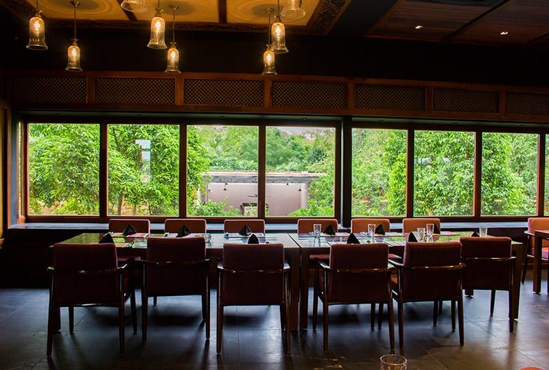 Rangeen dining room with garden-facing windows and pendant lighting