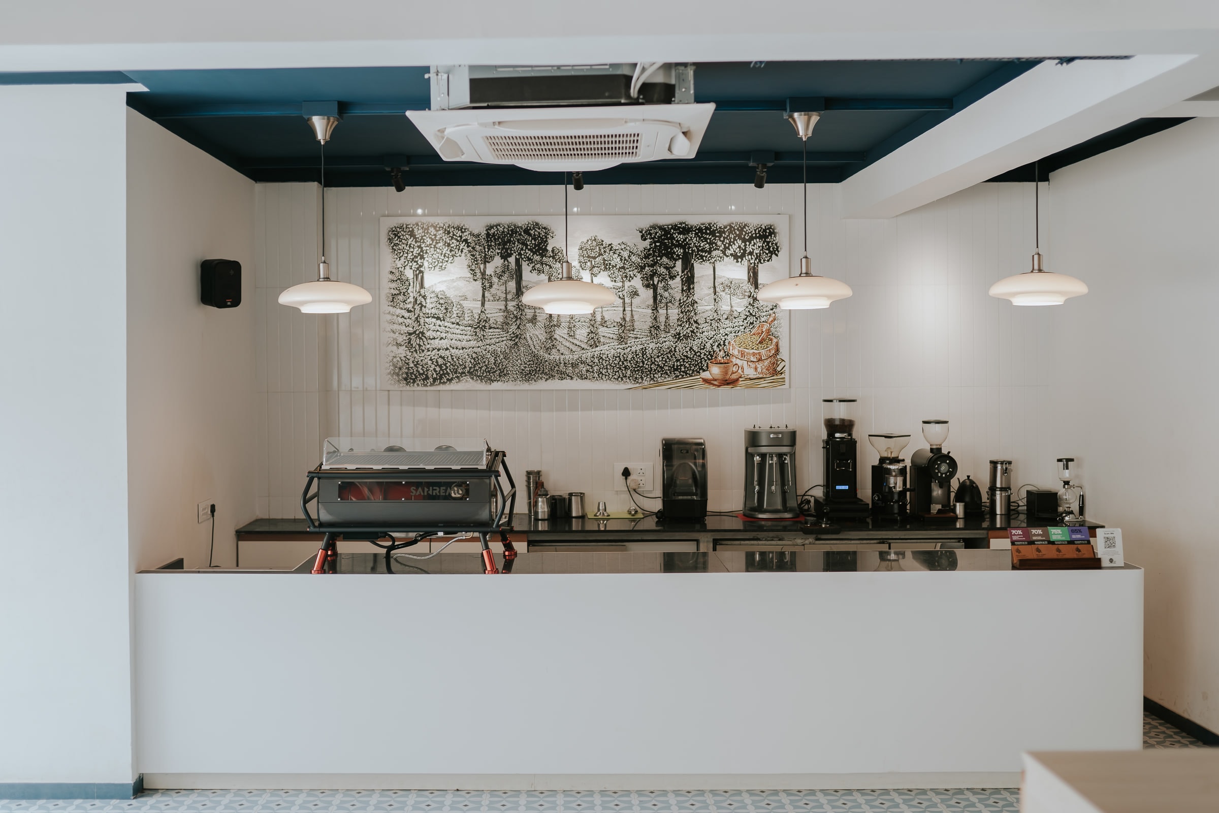 Coffee bar and brewing station along the white counter