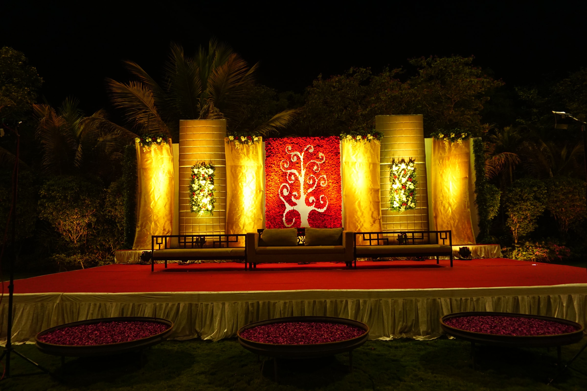 Golden and red stage setting with lit panels at night